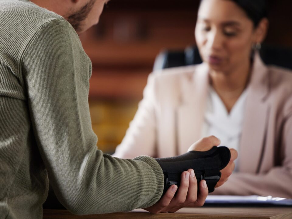 Image of a Person Wearing a Cast Talking to Their Layer